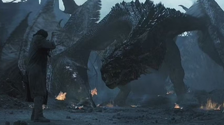 A human fires at a dragon in "Reign of Fire" (2002)