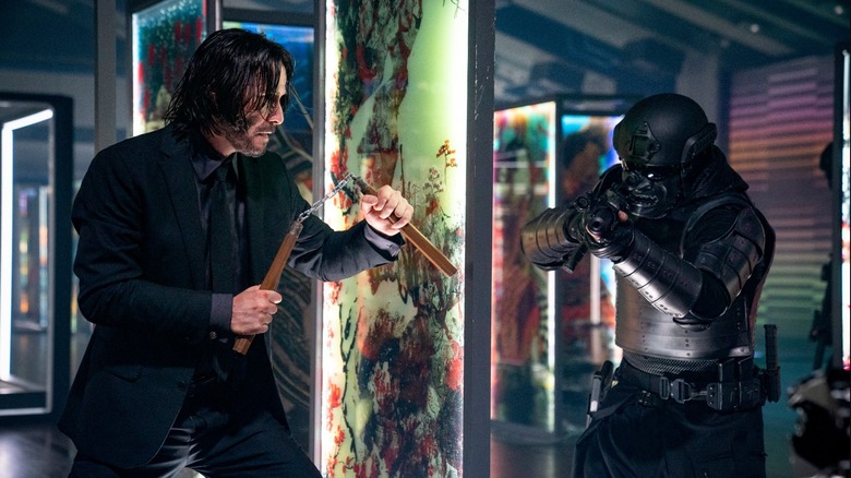 Keanu Reeves as John Wick fighting an opponent with nunchucks