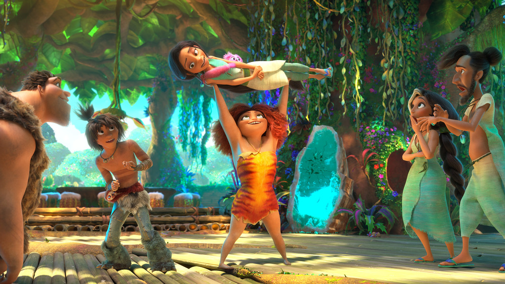 (from left) Ugga Crood (Catherine Keener), Grug Crood (Nicolas Cage), Guy (Ryan Reynolds), Eep Crood (Emma Stone) holding Dawn Betterman (Kelly Marie Tran), Hope Betterman (Leslie Mann) and Phil Betterman (Peter Dinklage) in DreamWorks Animation's The Croods: A New Age, directed by Joel Crawford