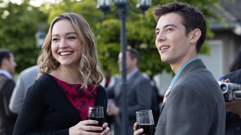 Megan Landry and Luke Chambers holding drinking glasses and smiling