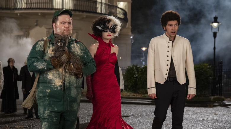 Paul Walter Hauser, Emma Stone and Joel Fry in "Cruella"