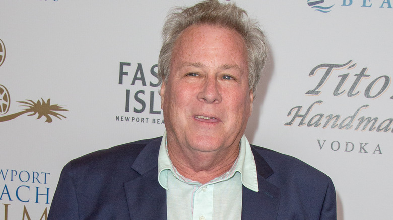 John Heard wears a blue sportcoat