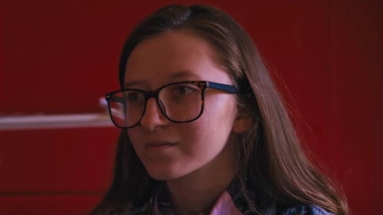 Girl with glasses looking on