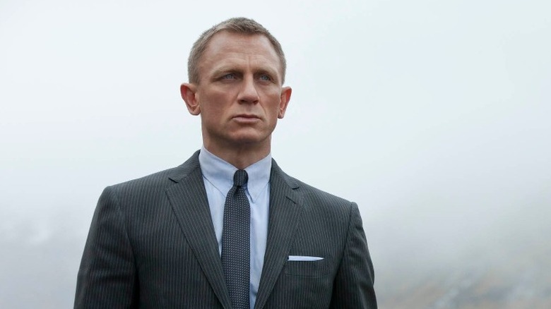 James Bond standing outside in a field