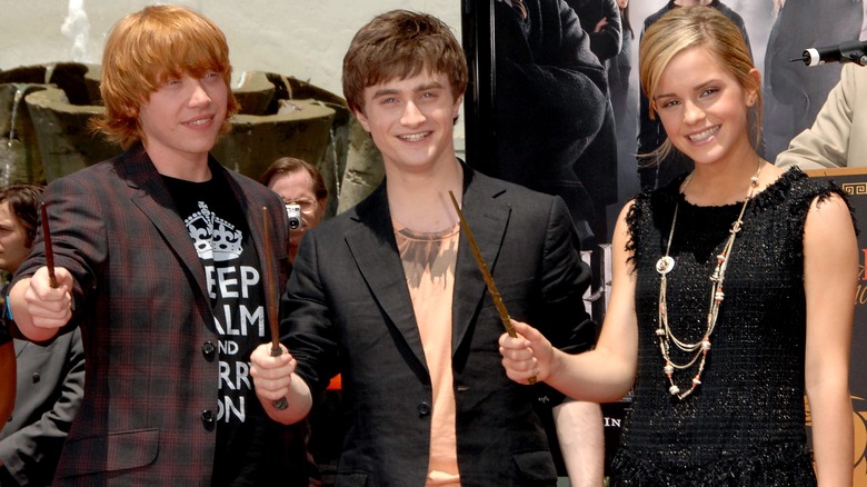 Rupert Grint, Daniel Radcliffe, and Emma Watson at a premiere