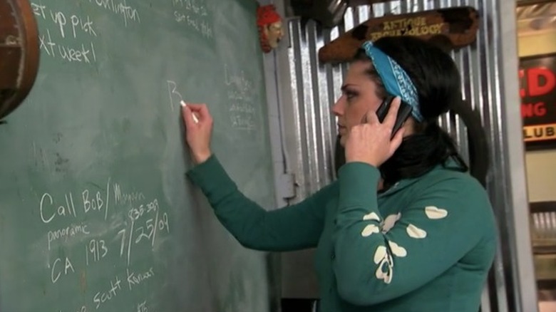 Danielle Colby writing on a chalkboard