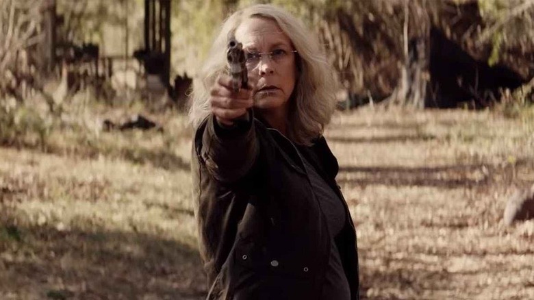 Jamie Lee Curtis as Laurie Strode pointing gun in Halloween 2018