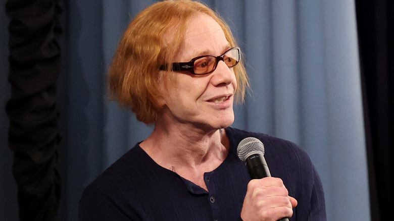 Danny Elfman holding microphone