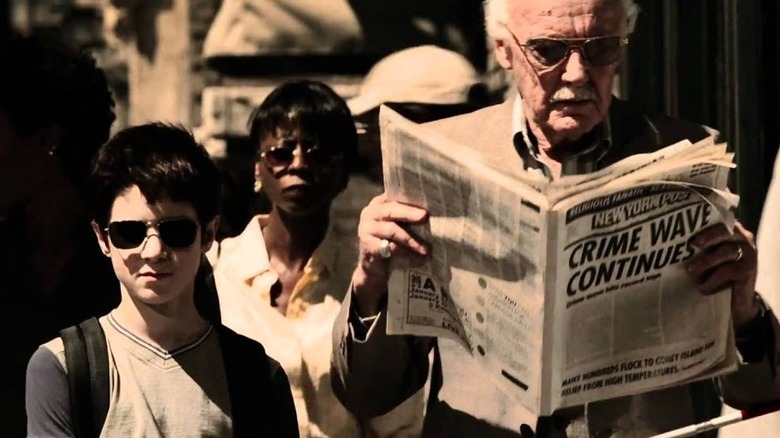 Stan Lee reads newspaper