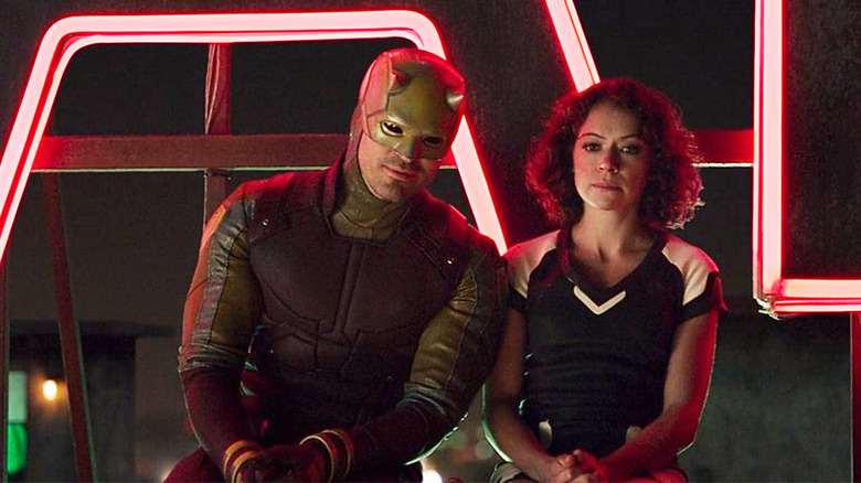 Daredevil and Jennifer Walters sit in front of a neon sign