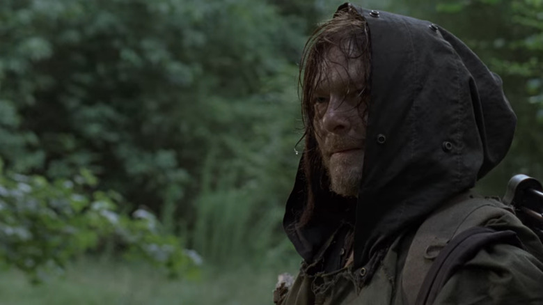 Daryl wearing a hood