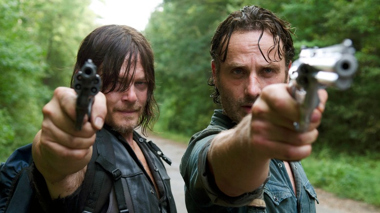 Daryl and Rick pointing guns