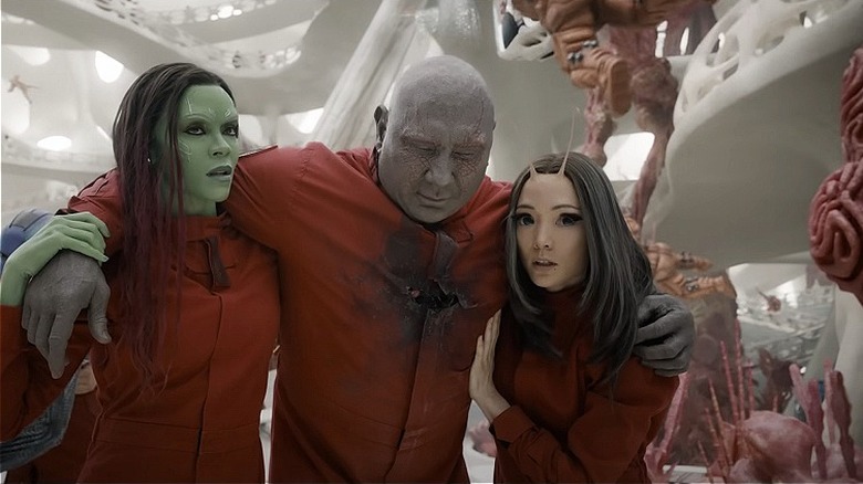 Gamora and Mantis holding up wounded Drax