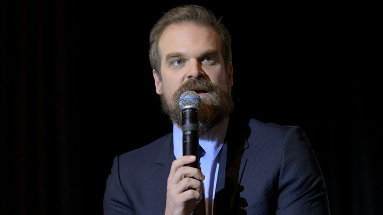 David Harbour holding microphone 