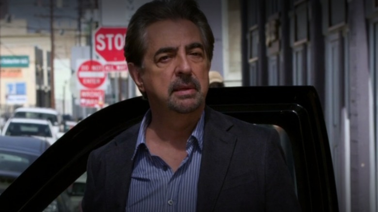 David Rossi stands by a car