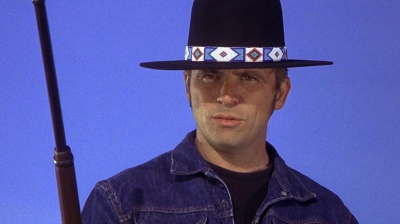 Billy Jack holding a rifle