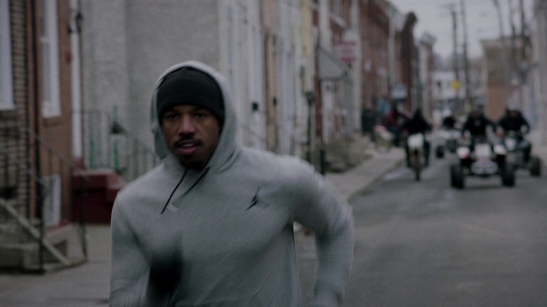 Adonis Creed running down the street