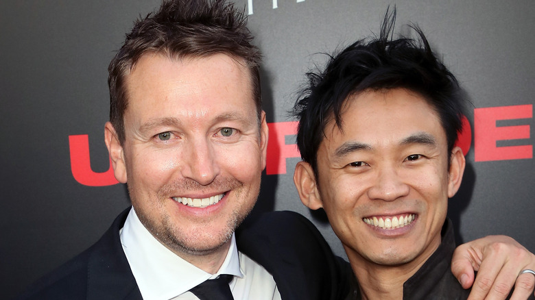 Smiling Leigh Whannell posing with James Wan