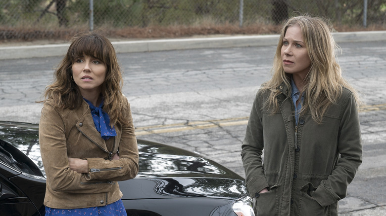 Judy and Jen standing by a car