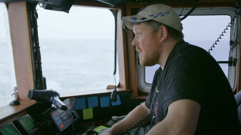 Casey MacManus standing at the helm