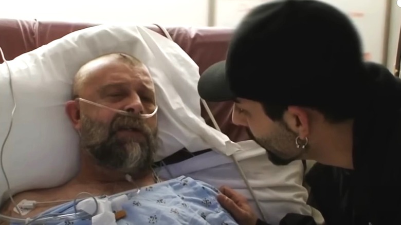 Phil Harris in hospital bed, Josh Harris by his side