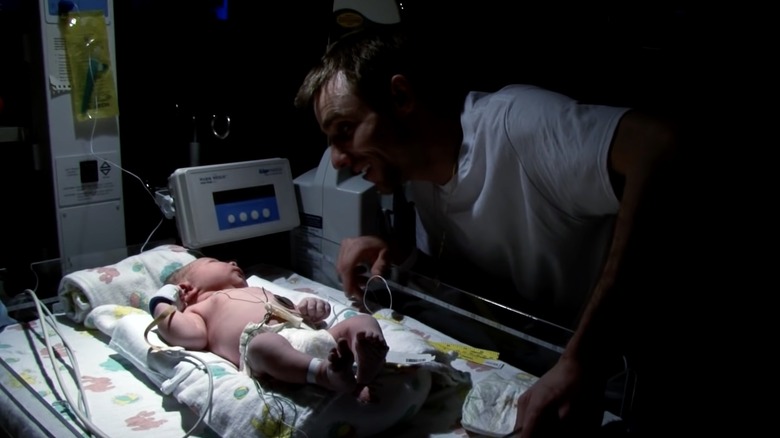 Jake Anderson smiling at his newborn first son on Deadliest Catch