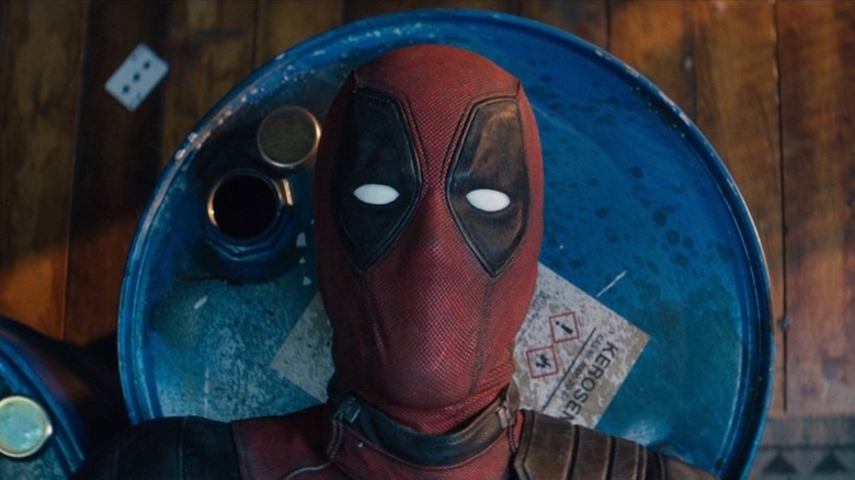 Deadpool lays atop barrels