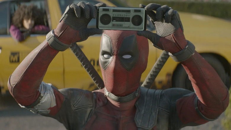 Deadpool holding a cassette player