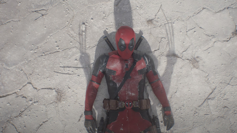 Wolverine standing over Deadpool