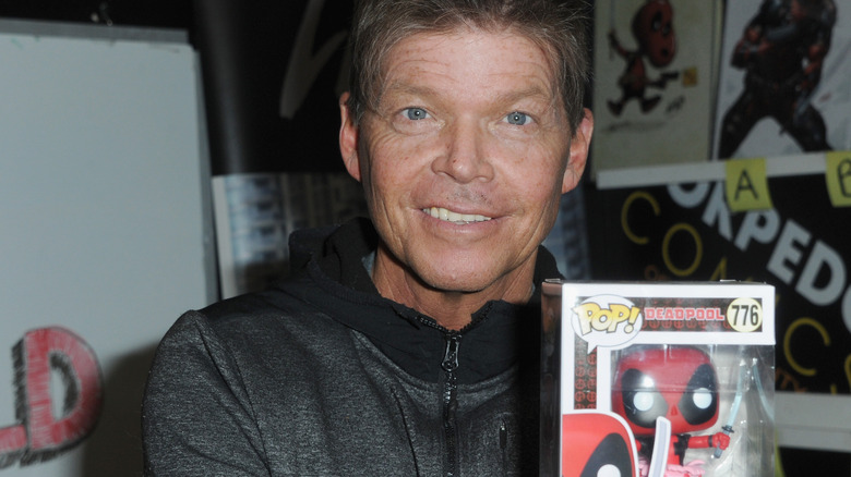 Rob Liefeld holding a Deadpool Funko Pop!