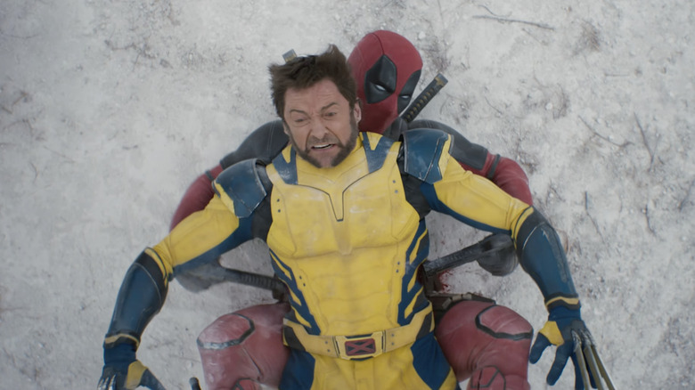 Deadpool shooting Wolverine's sides