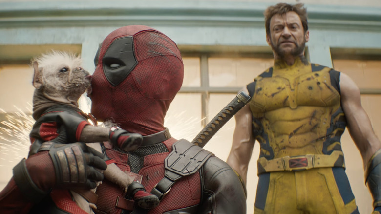 Wolverine staring at Deadpool holding dog