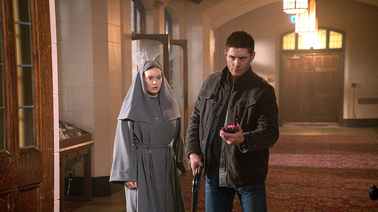 Dean next to nun with gun