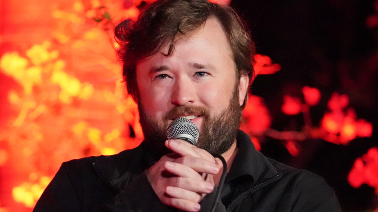 Haley Joel Osment speaking into a microphone