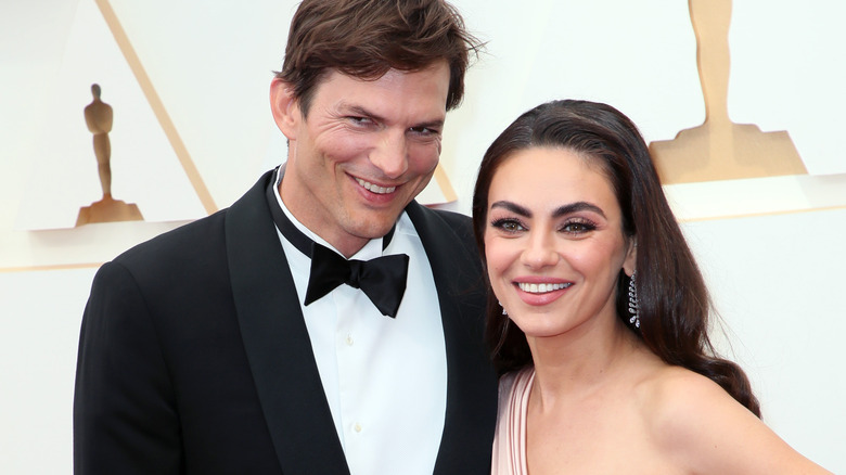 Mila Kunis and Ashton Kutcher pose at event 