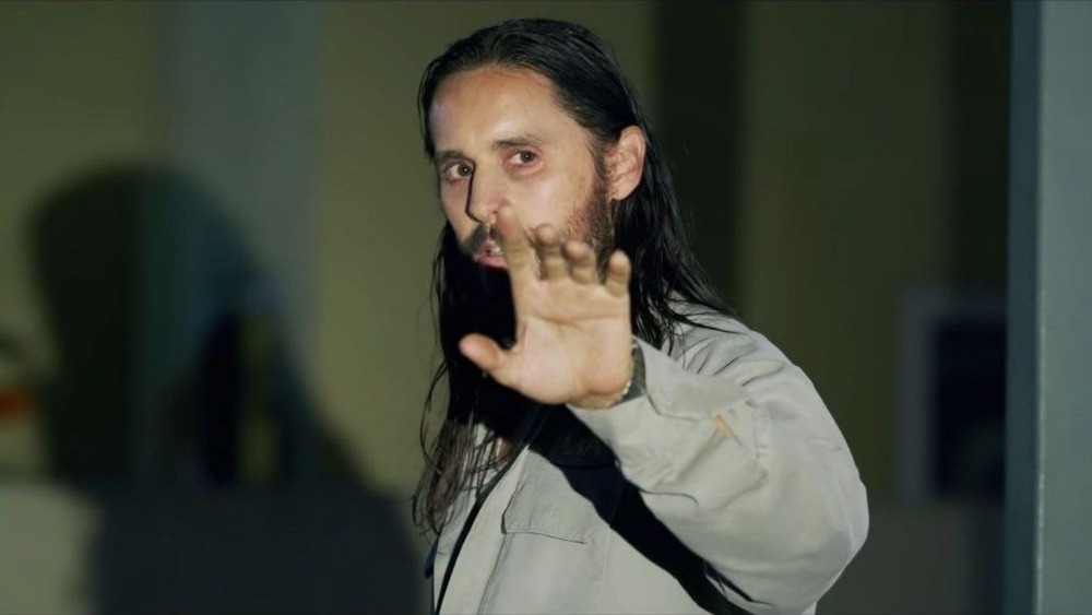 Jared Leto stands in spotlight