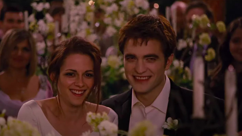 Bella and Edward smiling at wedding reception 