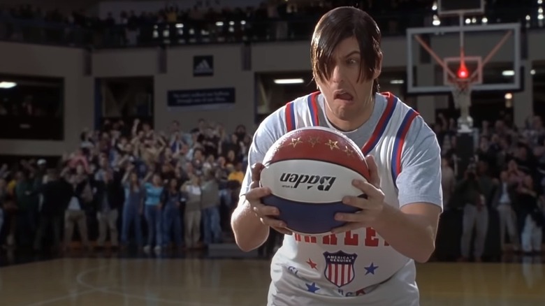 Nicky holds a basketball as a crowd cheers behind him