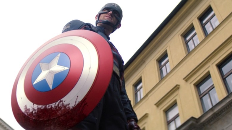 John Walker holding a bloody shield