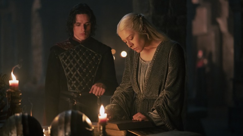 Jacaerys with Rhaenyra as she looks at a book on House of the Dragon