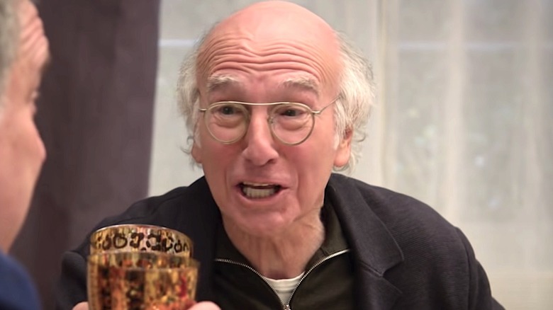 Larry David toasting