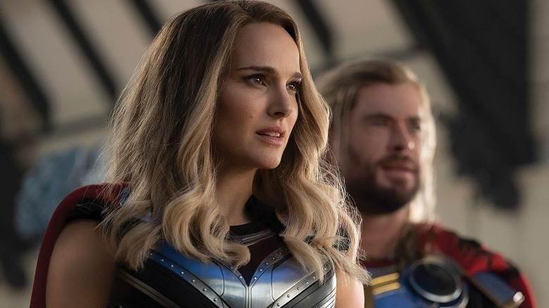 Jane Foster standing in front of Thor