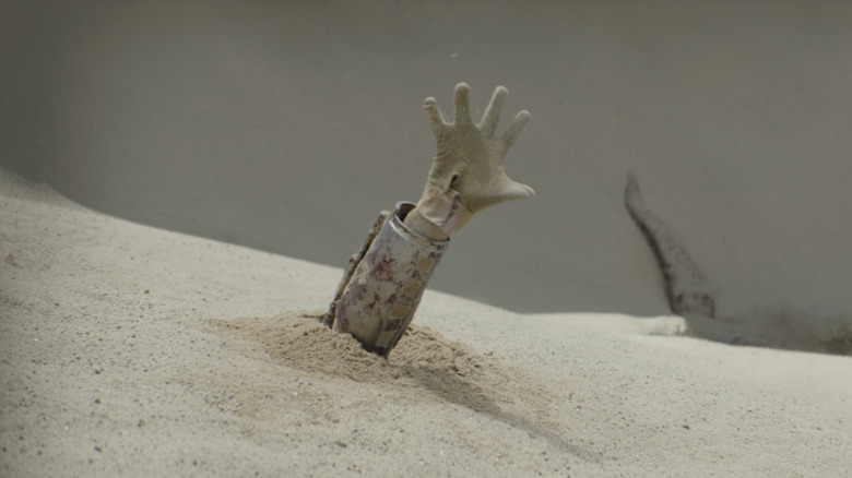 Boba Fett's hand coming out of sand