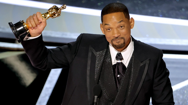 Will Smith celebrates with his Best Actor trophy 