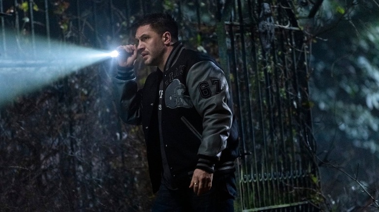 Tom Hardy holding flashlight