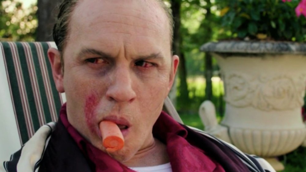 Tom Hardy as Al Capone smokes a carrot