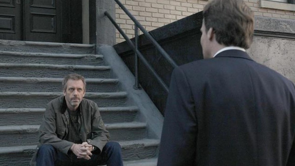 Hugh Laurie as Gregory House sits on stoop