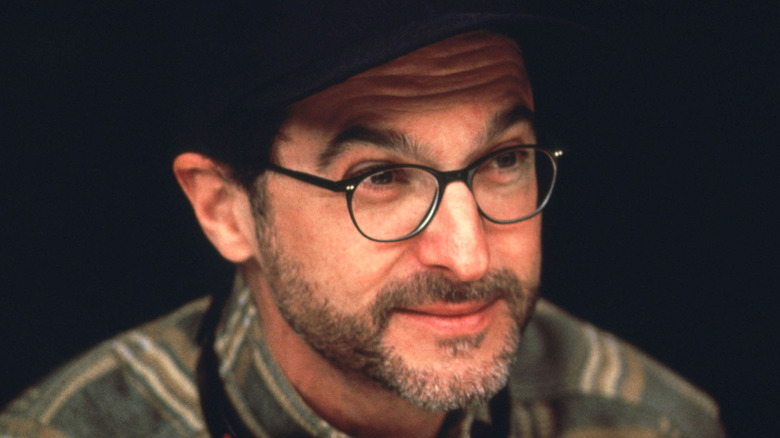 Martin Brest wearing glasses and a hat