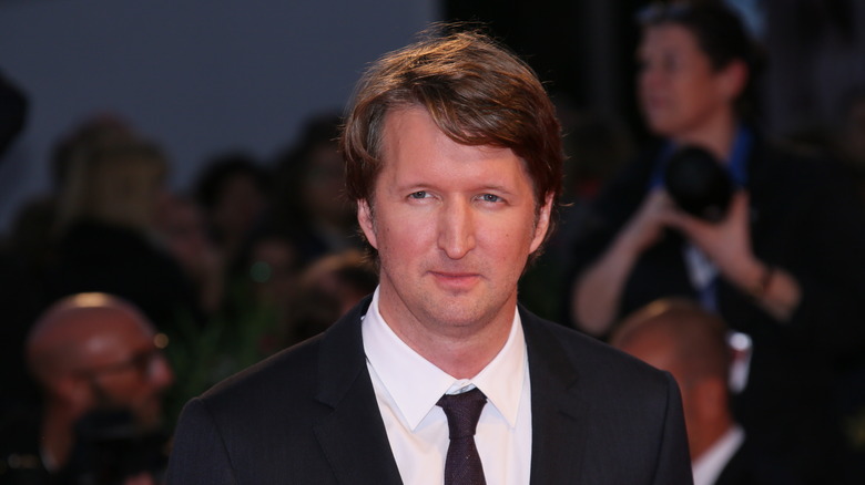 Tom Hooper wearing a suit and tie