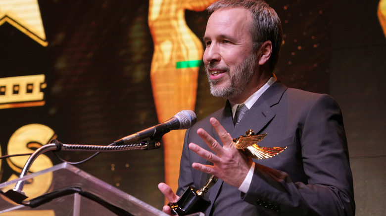 Denis Villeneuve holding award